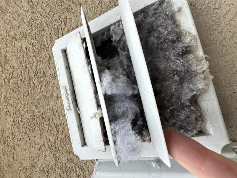 Vent louver packed with lint before cleaning